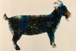 A goat postcard with a galaxy style pattern on it.