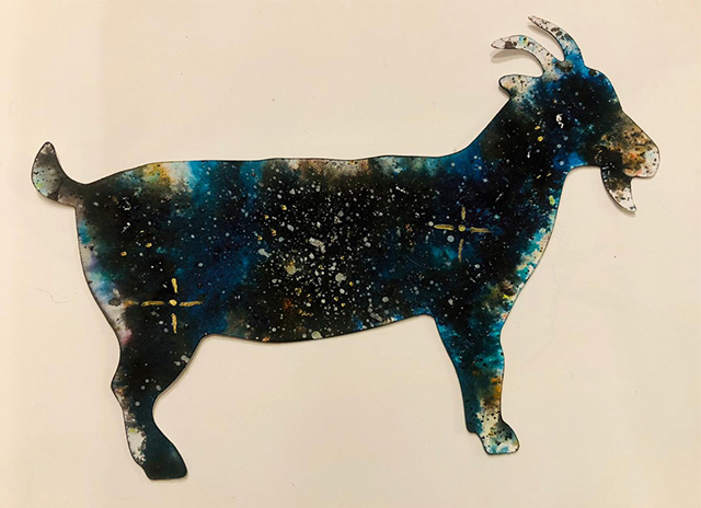 A goat postcard with a galaxy style pattern on it.