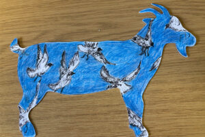 A goat postcard decorated with white birds on a blue background.