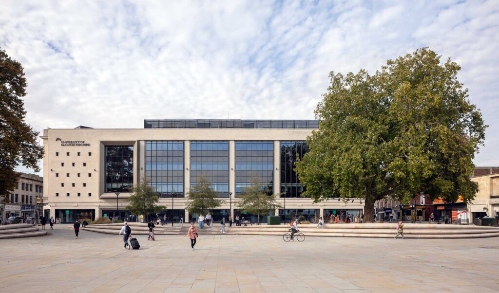 View of City Campus across Kings Square with people walking and cycling.