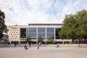 View of City Campus across Kings Square with people walking and cycling.