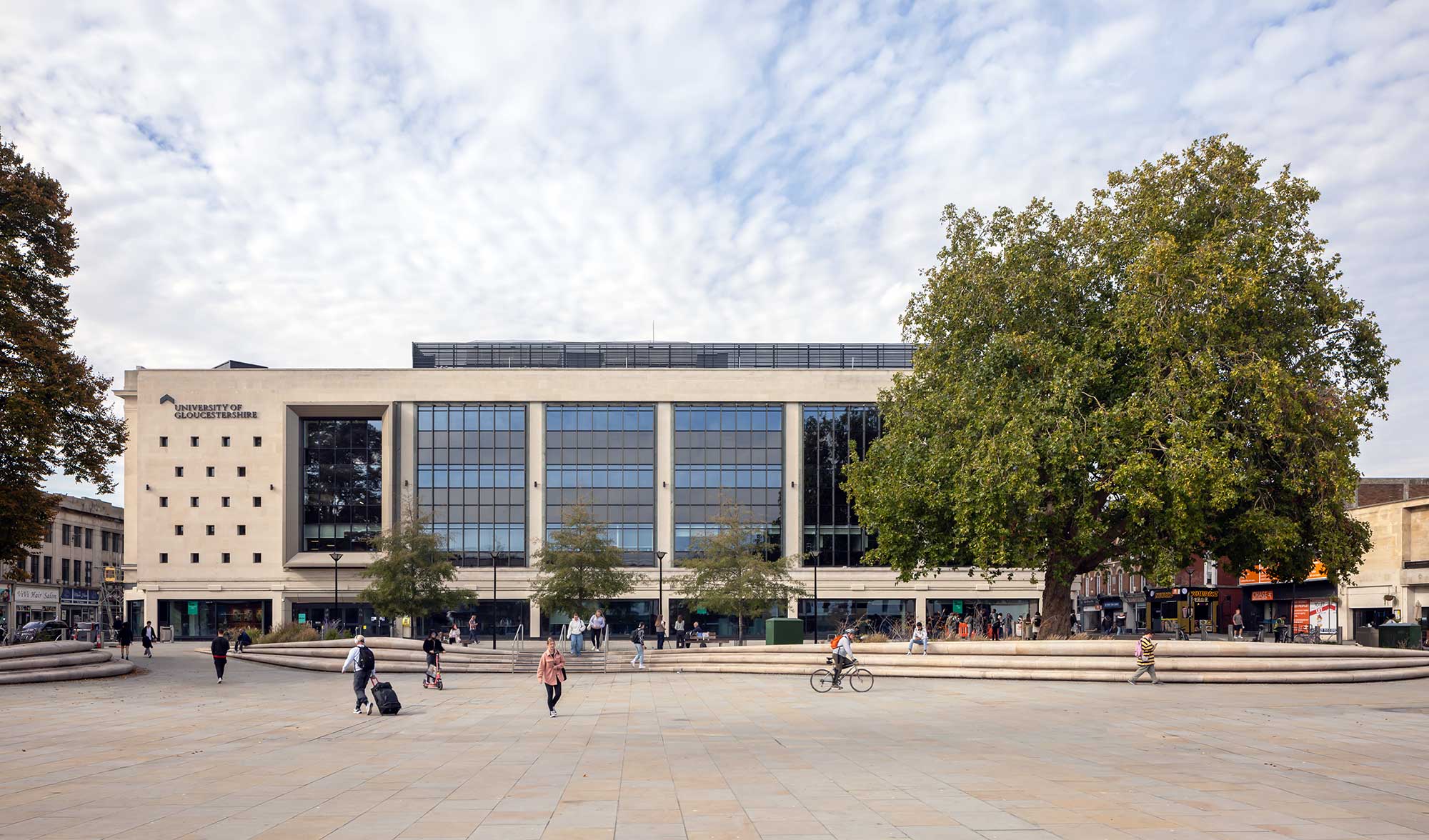 View of City Campus across Kings Square with people walking and cycling.