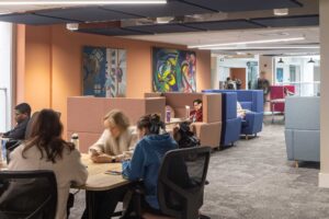 Students sitting in the soft seating areas inside City Campus.