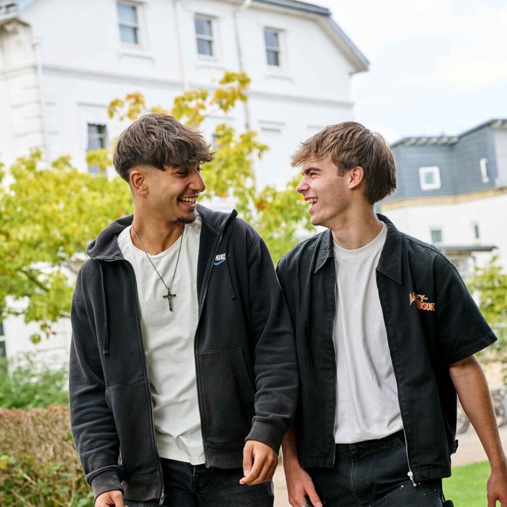 Two male students walking together through Park Campus.