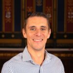 Head and shoulders photo of James Cooper smiling.