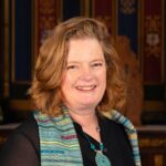 Head and shoulders photo of Nicola de Iongh smiling.