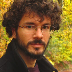 Photo of poet Stewart Carswell in a woodland.