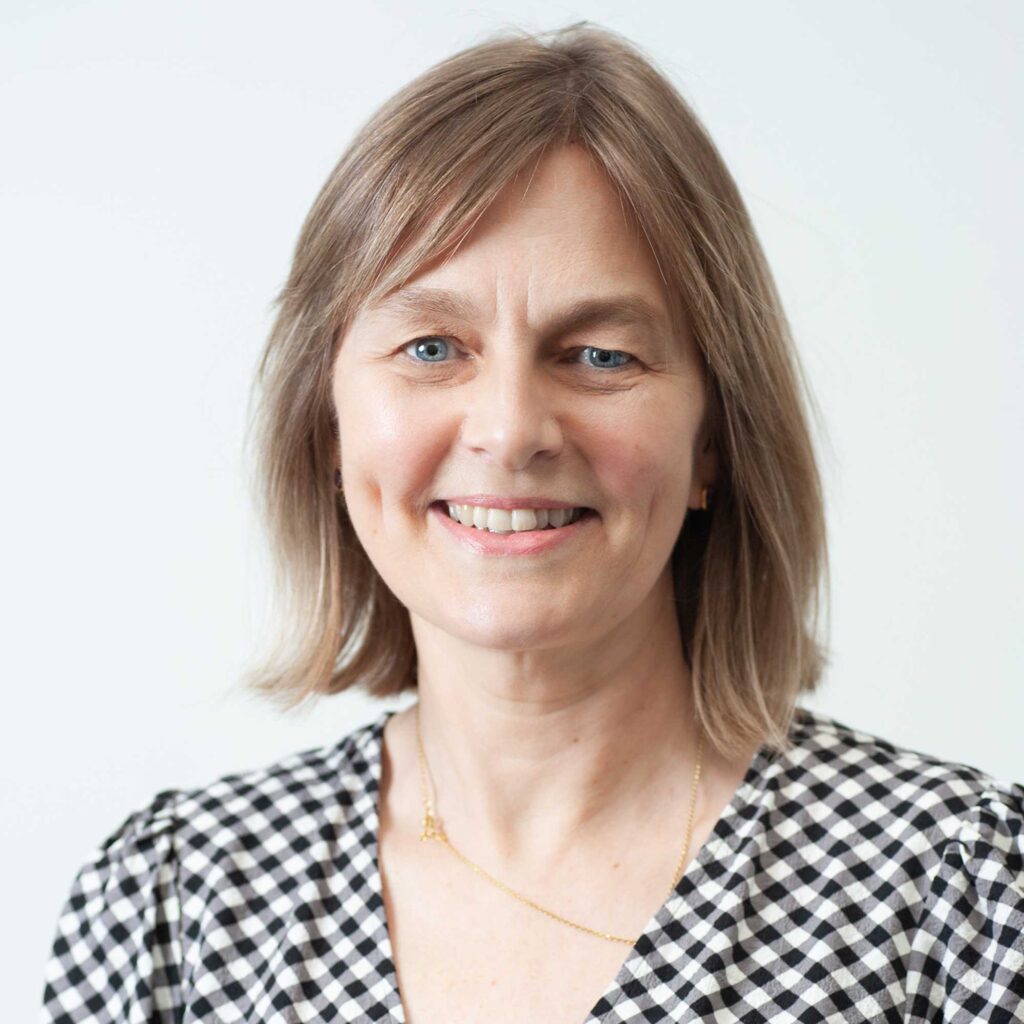 Head and shoulders portrait photo of Carla Stanton, looking directly at the camera and smiling