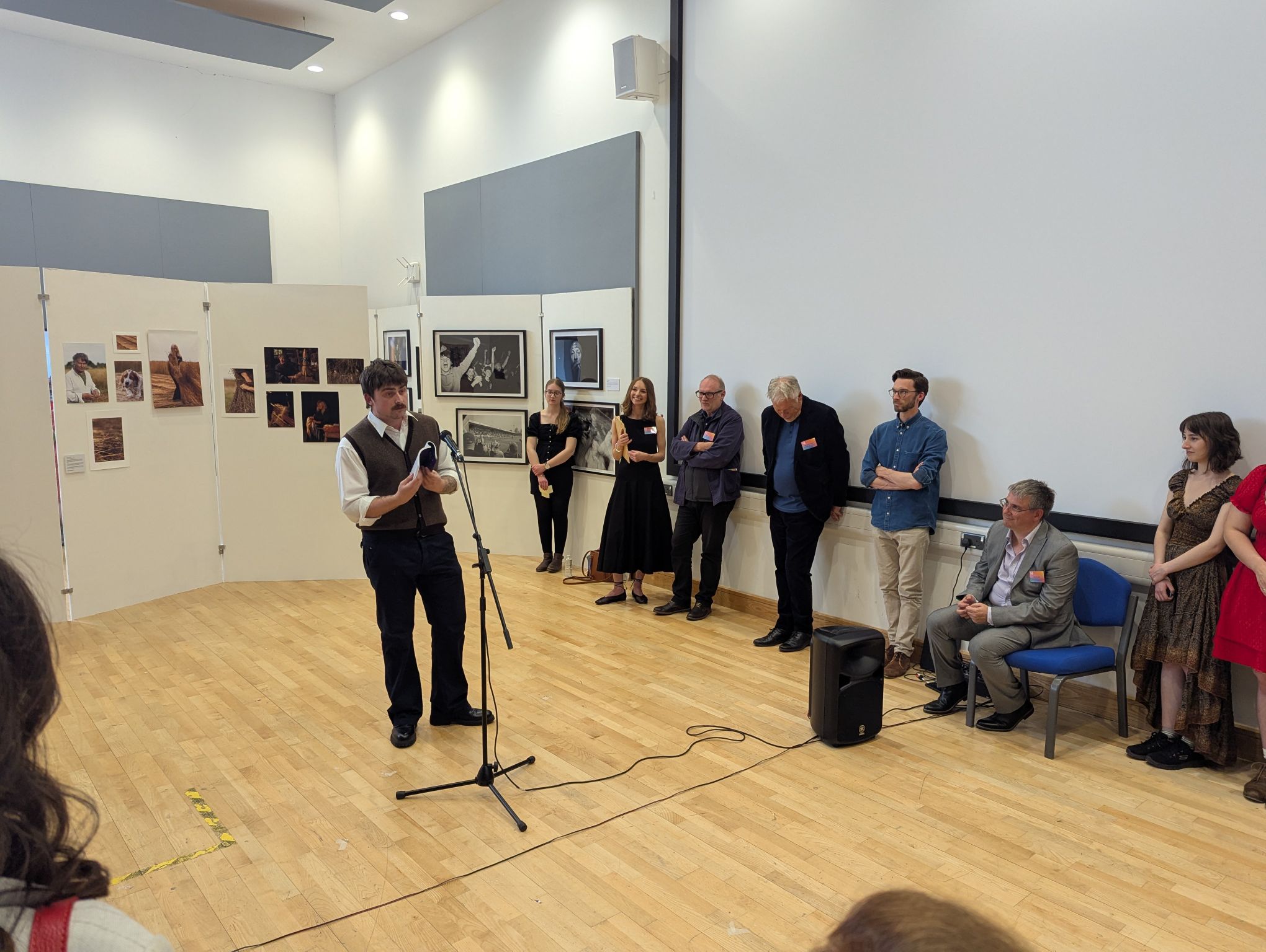A student of English gives a presentation in front of others during the UoG Degree Show.