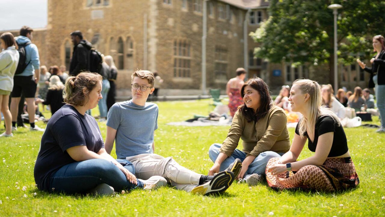 Students chatting on the grass on FCH.