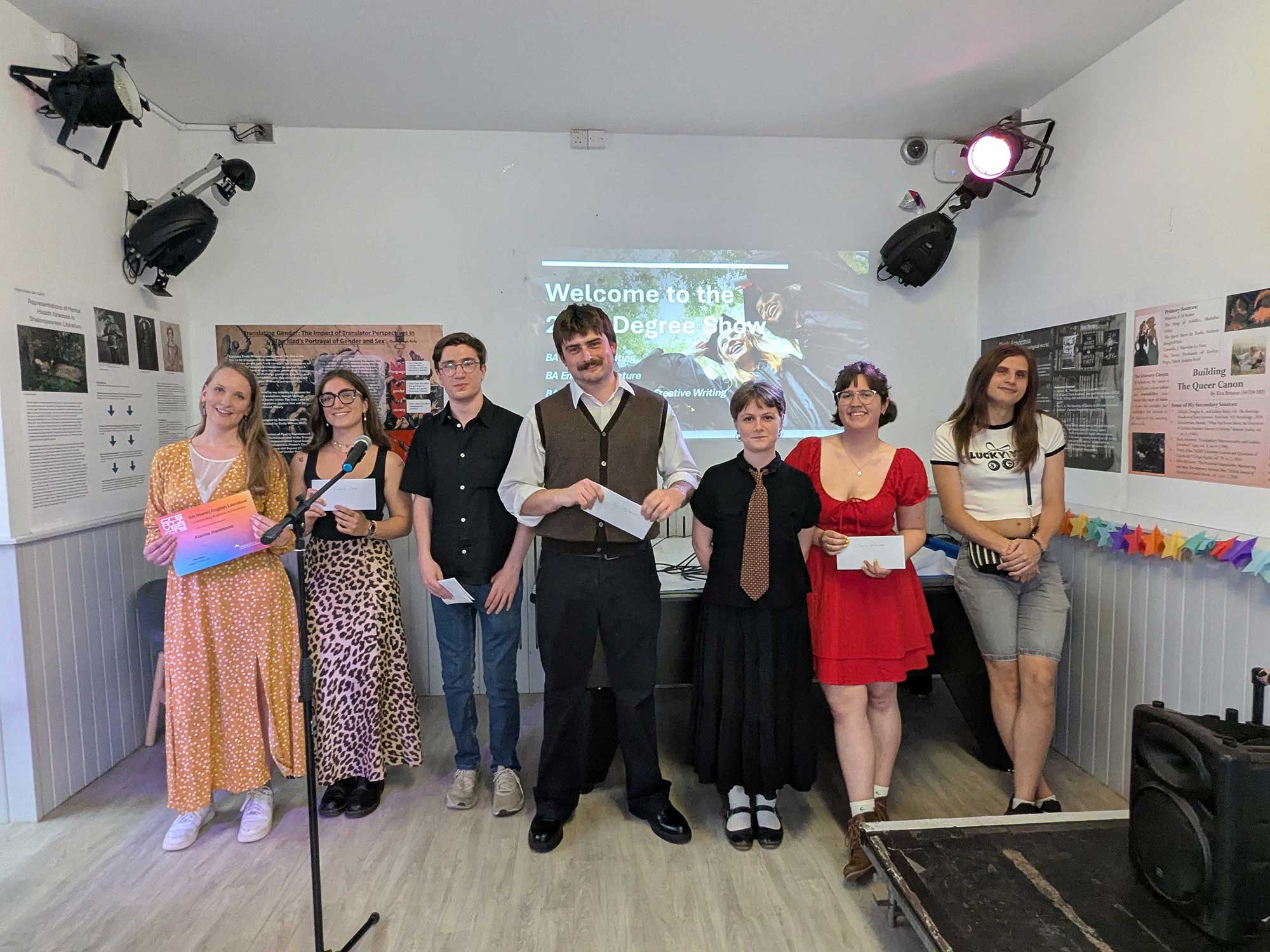 Students of English lined up posting for a photo at the Degree Show.