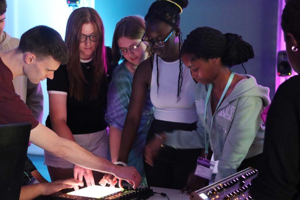 Students are shown how a piece of sound equipment works.