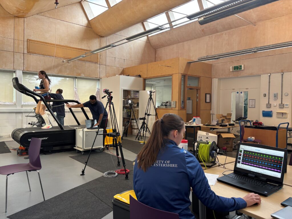 Female student running on a treadmill in the physiotherapy lab with cameras around her monitoring her movement.