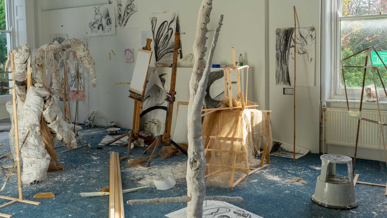 A room filled with plaster sculptures and drawings.