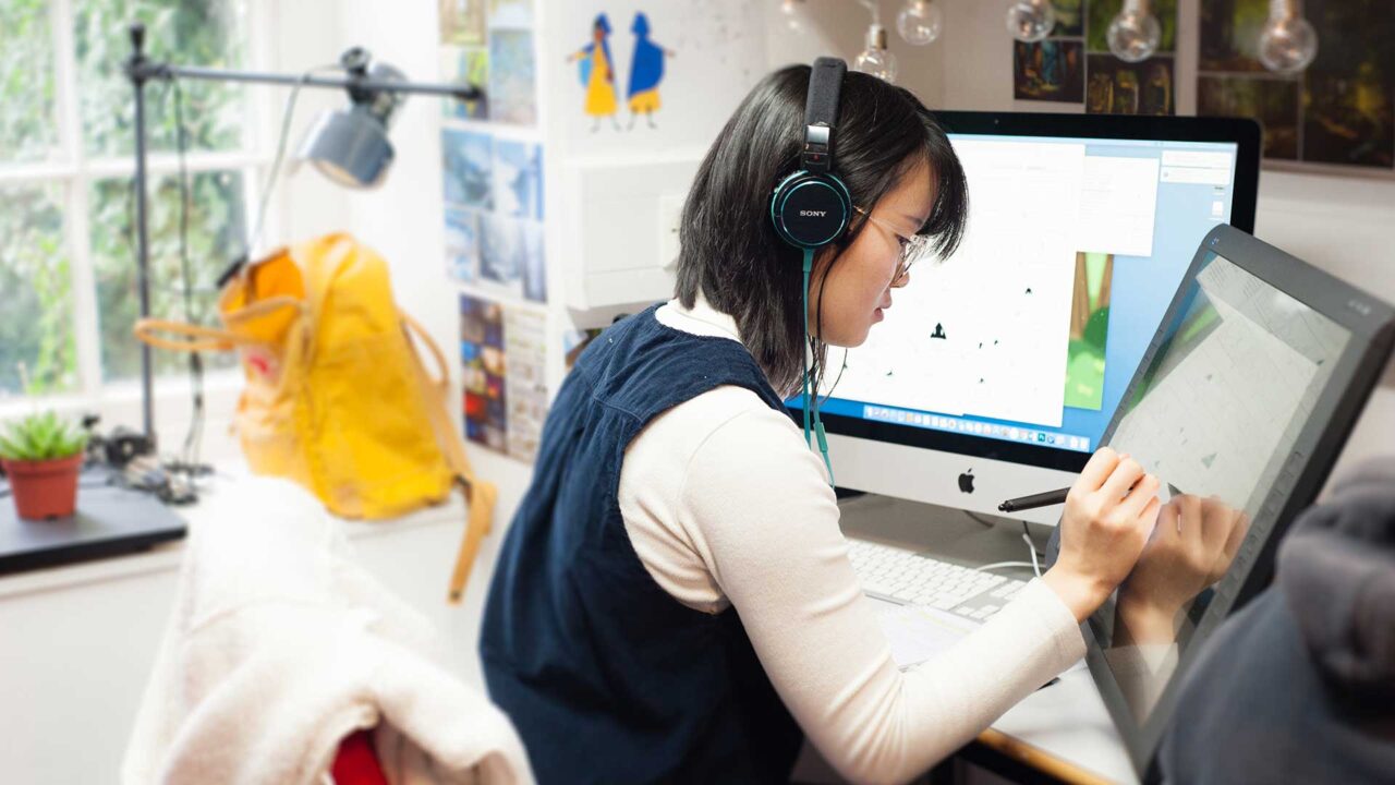 A student uses an interactive screen in an animation studio.