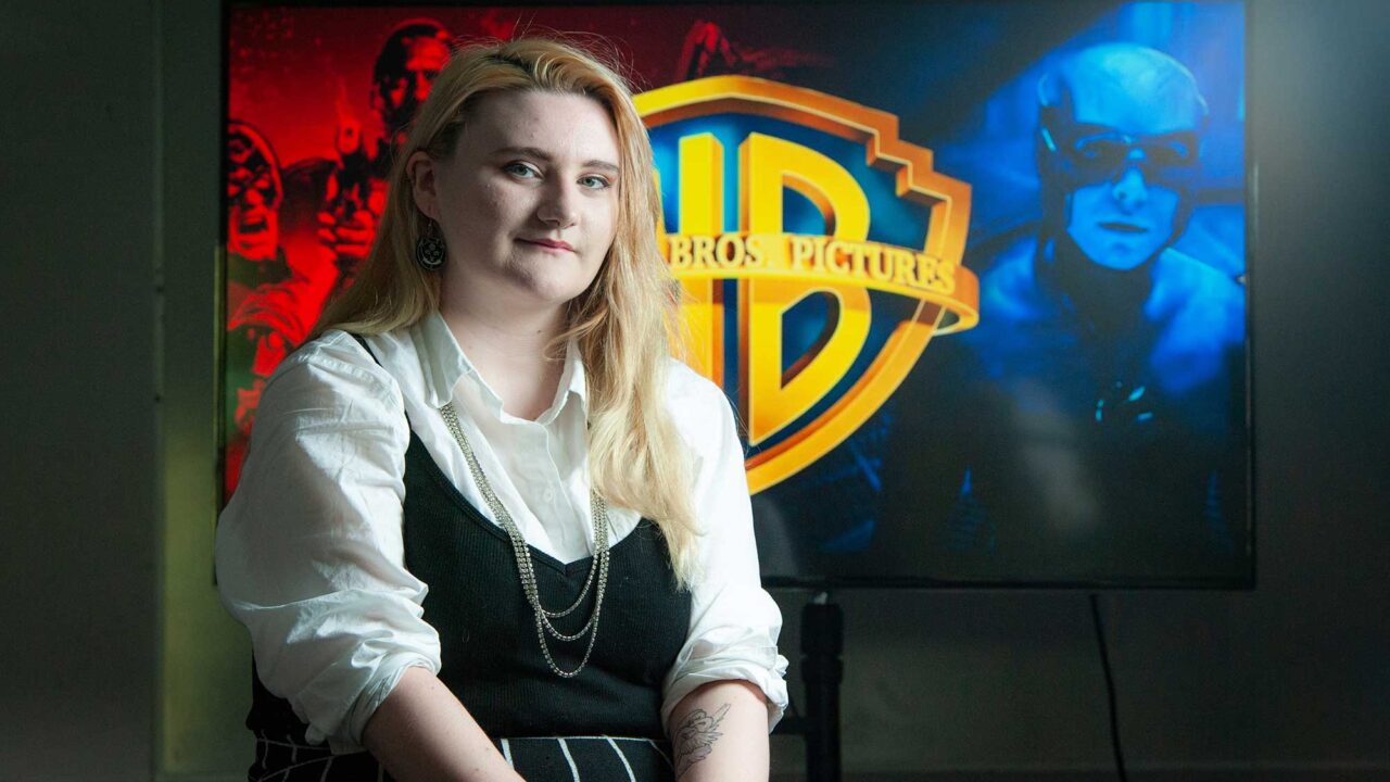 Seraphina sitting in front of a Warner Bros logo.