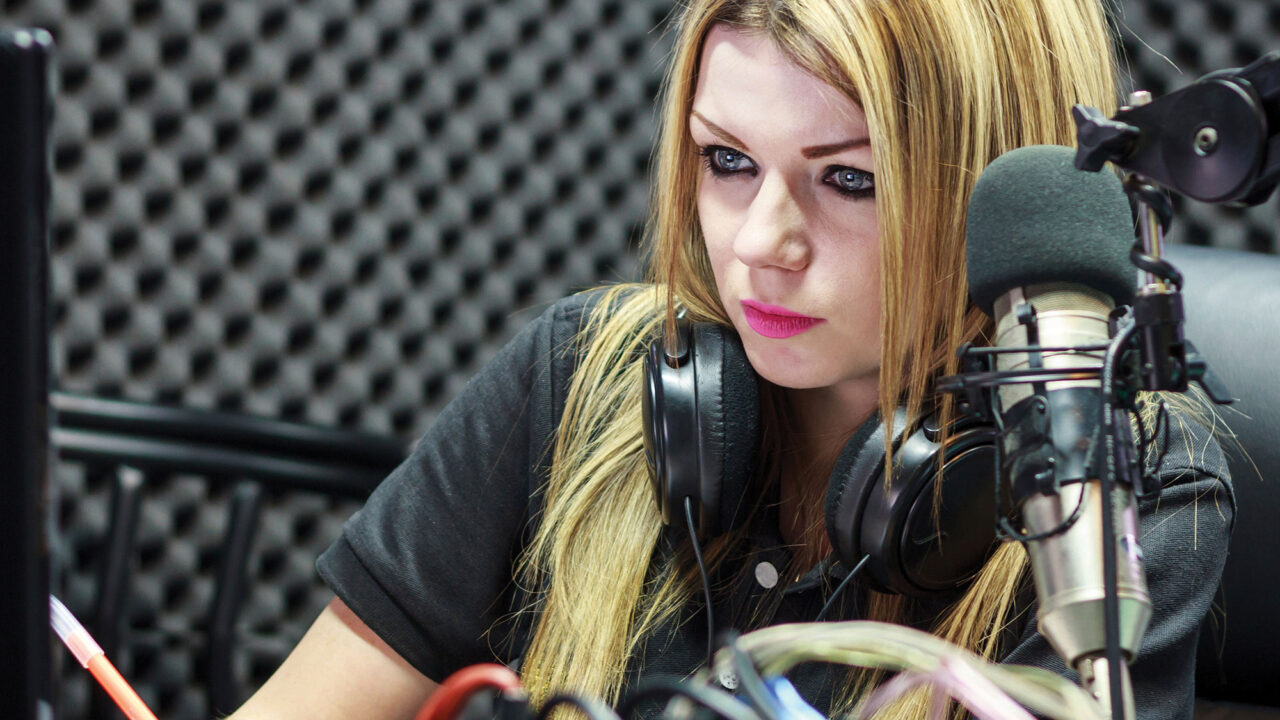 Student in podcast recording studio