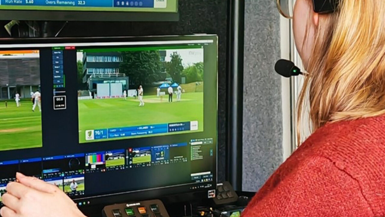 A student wearing a headset uses editing facilities in the Journalism outside broadcast truck.