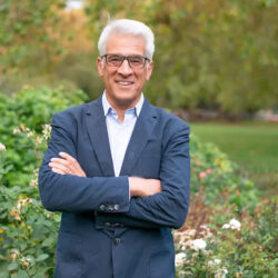 Reverend Canon Steve Chalke MBE, founder of the Oasis Trust smiling with his arms folded.