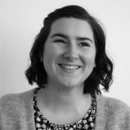 Black and white photo of Jess smiling.