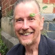 A photo of Red smiling outside.