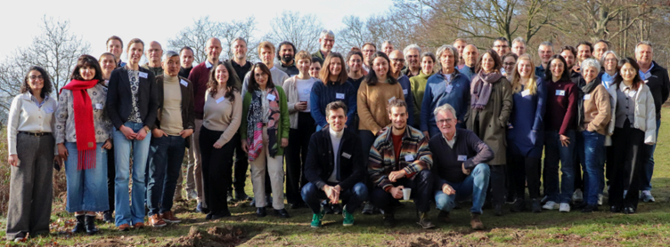 a large group of people smiling and looking at the camera