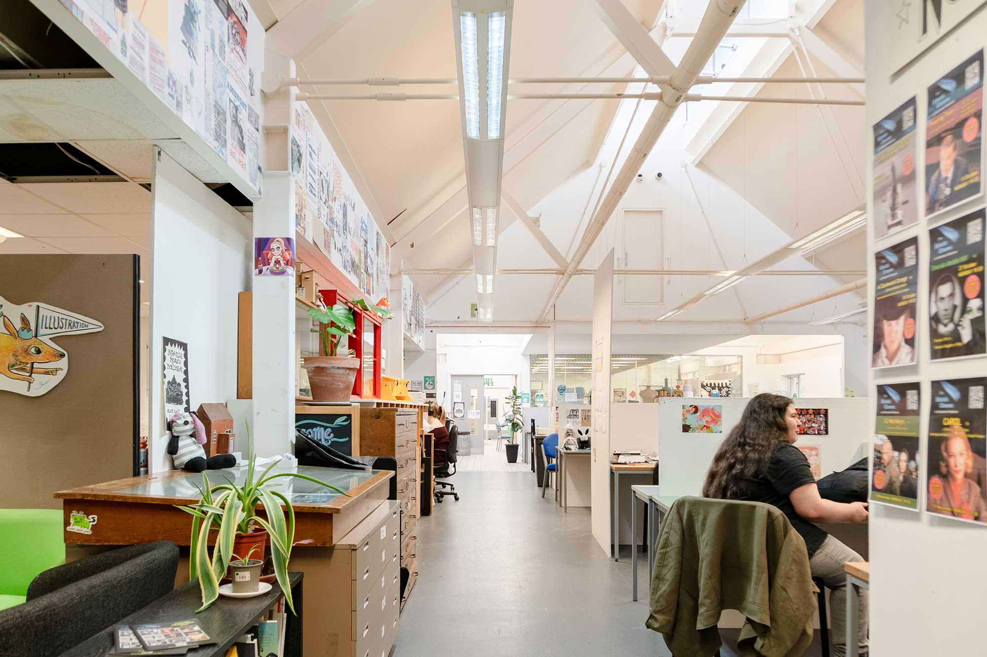 The illustration studios with a light, bright vaulted ceiling and students working at tables.