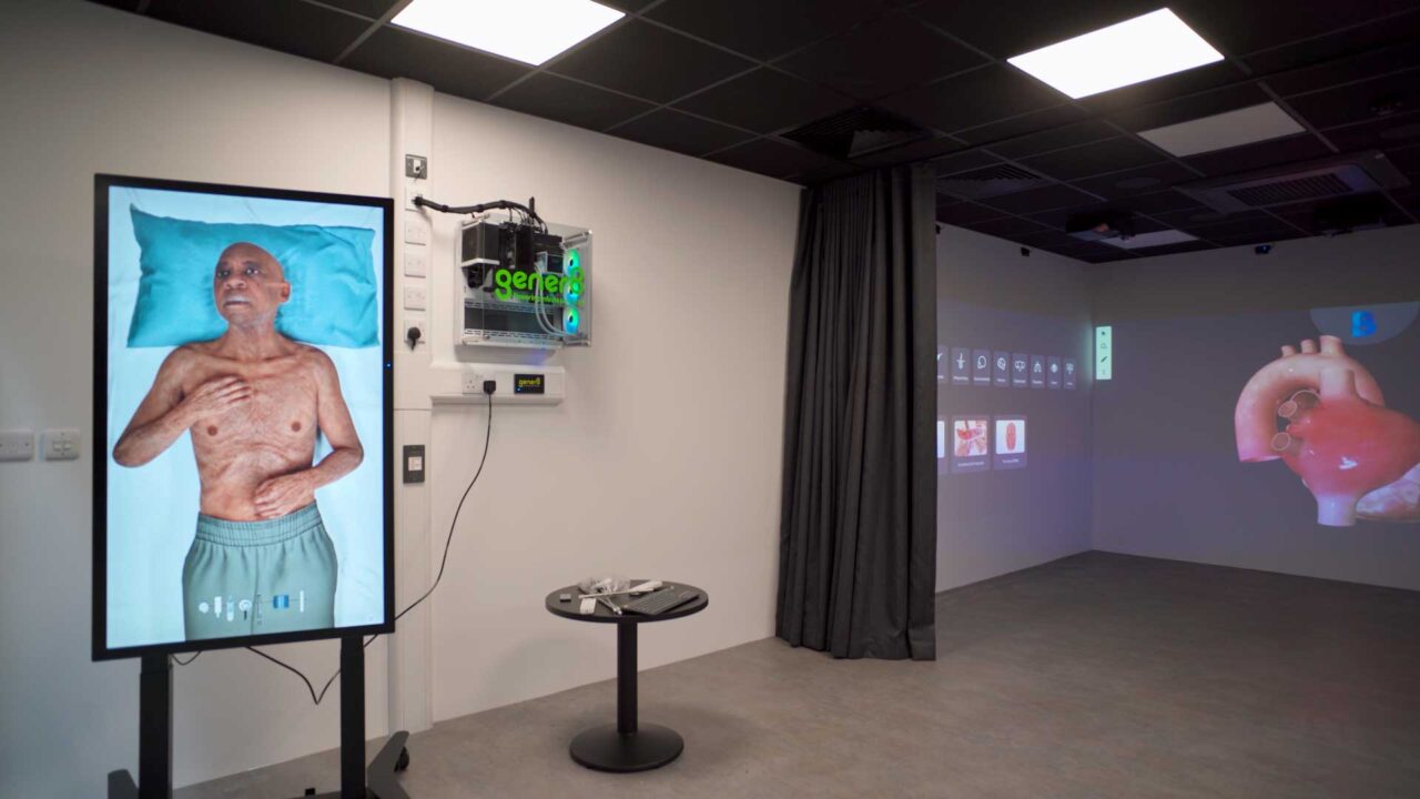 The immersive simulation space at FutureSIM with digital screens showing a patient and internal organs.
