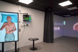 The immersive simulation space at FutureSIM with digital screens showing a patient and internal organs.