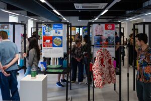 Visitors looking at graphic design work on display at the 2025 degree show.