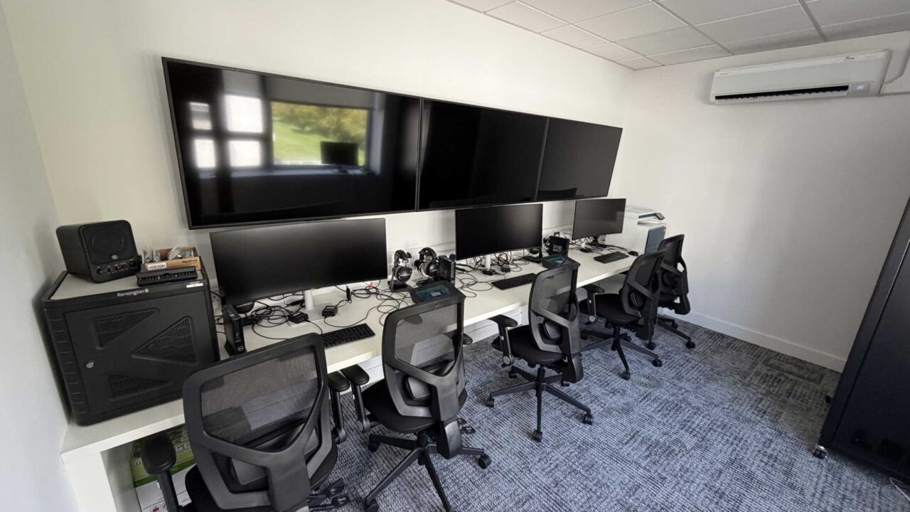 The Hydra Command Suite with desks with screens and computers.