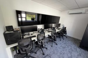 The Hydra Command Suite with desks with screens and computers.