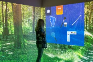 A student looks at the digital screens showing a simulated crime scene in at the FutureSim facility.