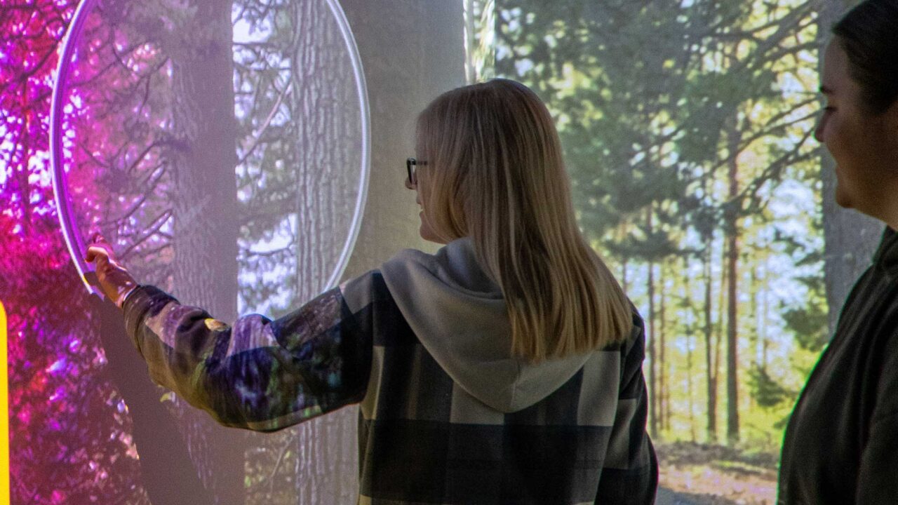 A student interacts with the digital screens showing a simulated crime scene in at the FutureSim facility.