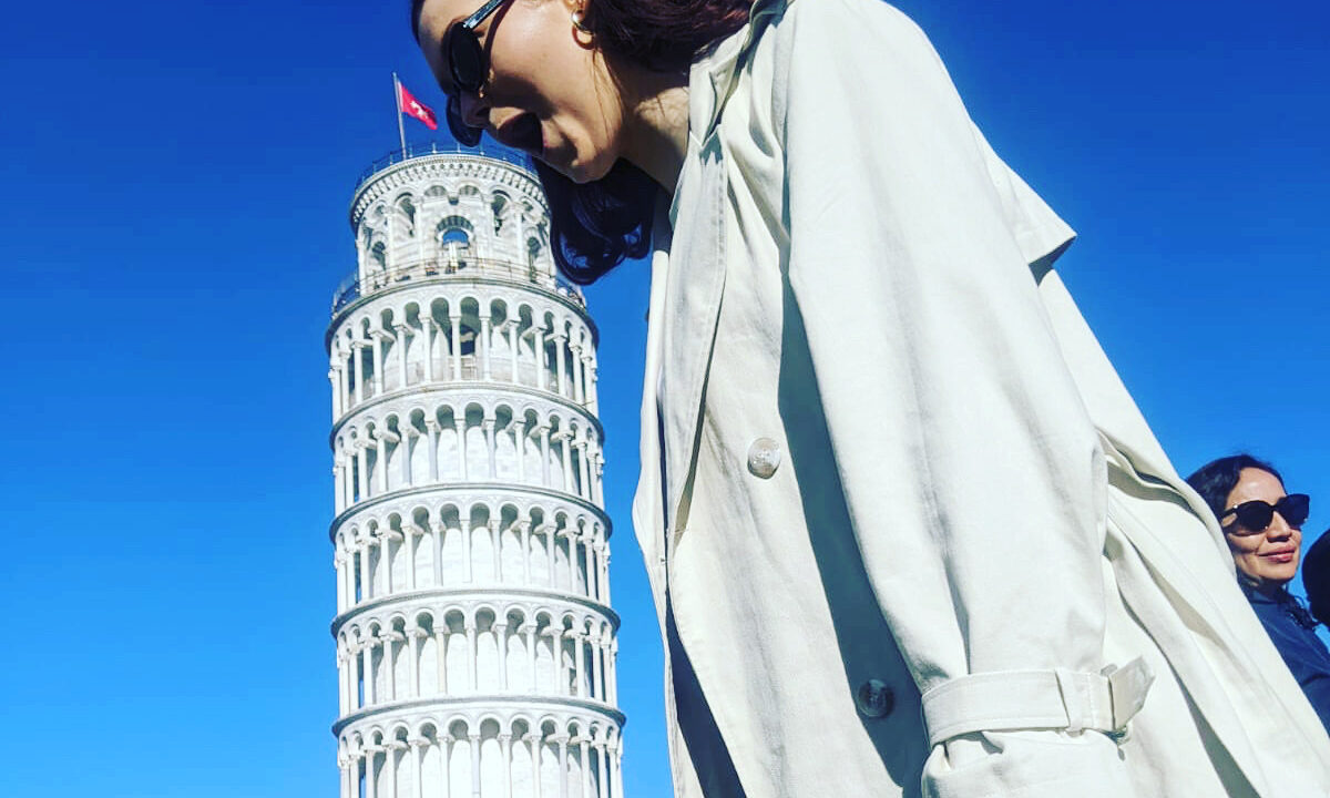 A student on a field trip to Italy pretends to take a bite out of the Leaning Tower of Pisa.