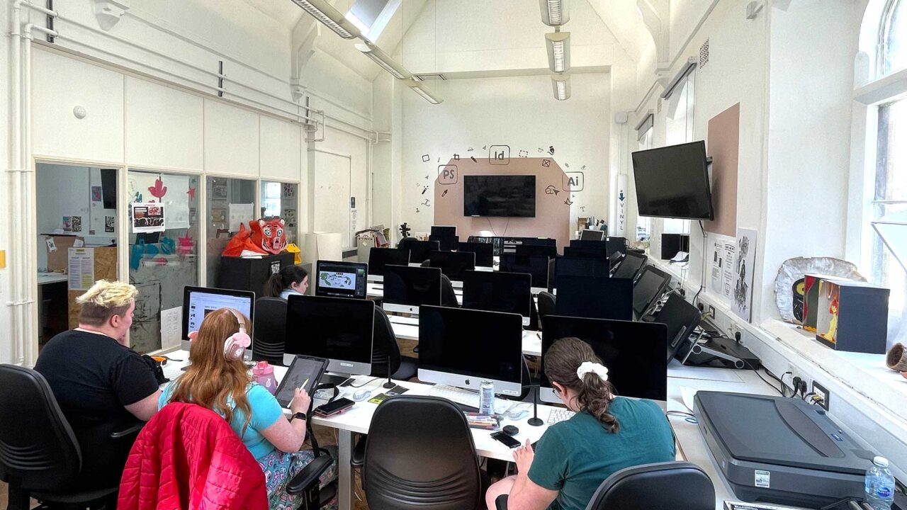The digital suite with students working on Macs and tablets.