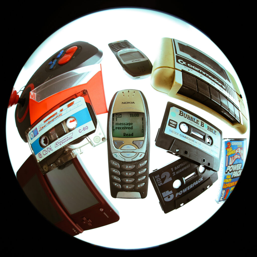 old cassette tapes, a tape player and mobile phones
