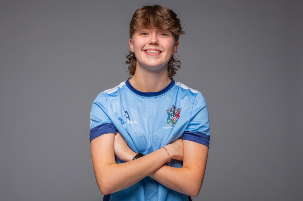 a head and shoulders photo of Abi wearing a sky blue sports top