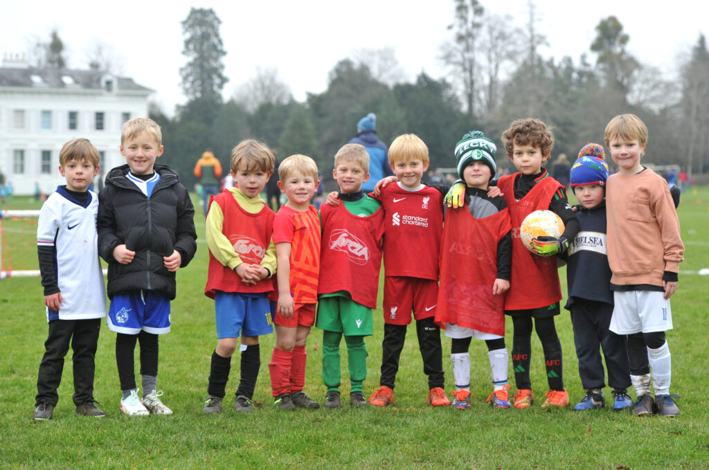 a group of young boys wearing football kits
