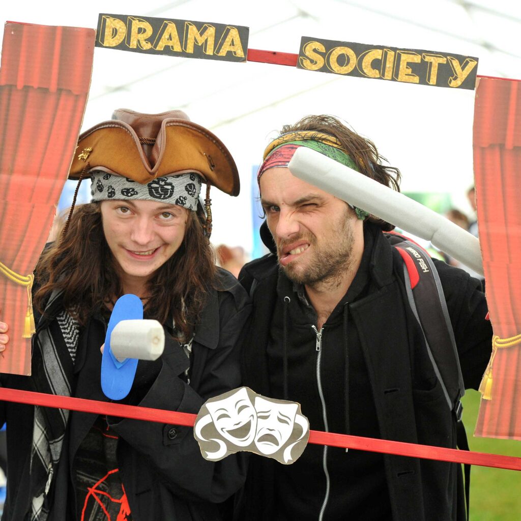 Two Drama Society students make silly faces as they pose for a photo at the Welcome Fayre.