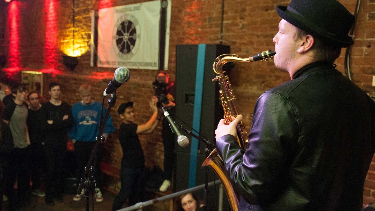 Music student playing saxaphone on stage