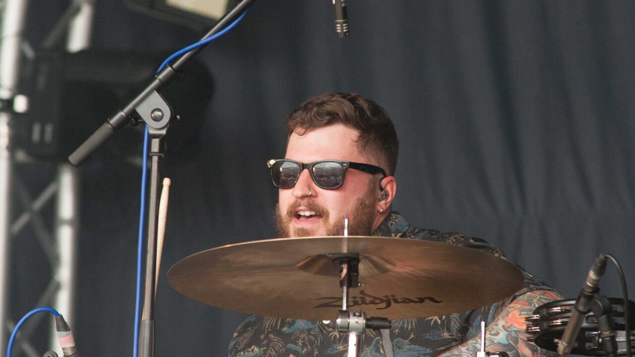 Drummer performing on a festival stage